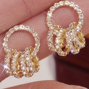 14 KARAT / STERLING ENCRUSTED WITH WHITE TOPAZ CIRCLES IN CIRCLE 1 IN DANGLE